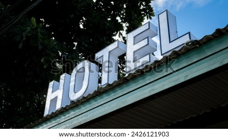 Close up of vintage retro hotel sign in large bold capital letter font on rooftop of accommodation