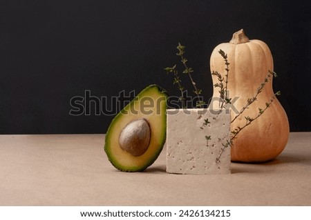 Delicious ready to eat plant-based food minimalist art or background with squash bread avocado tofu and sign black and beige colors