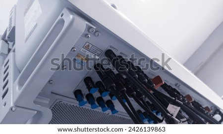 Cable connecting the power from the solar panel to the inverter with shiny light. Cable string connection on inverter control solar panel. Socket input supply voltage and Technology of solar energy. Royalty-Free Stock Photo #2426139863