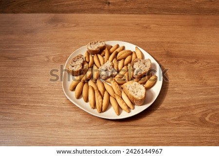 plate with micro rolls called picos and pieces of bread with seeds