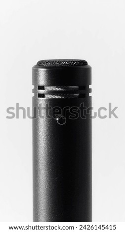 Macro photography black microphone housing on white background high contrast product photography