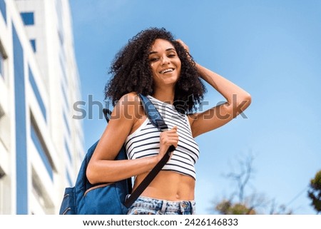 Photo of cheerful gorgeous girl traveling alone enjoying beautiful summer time sunny blue sky carefree peaceful life outside
