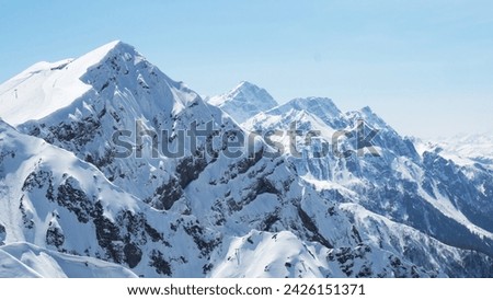 Beautiful snowy peaks of the Caucasus Mountains. Krasnaya Polyana Rosa Khutor Ski Resort, Russia. Royalty-Free Stock Photo #2426151371