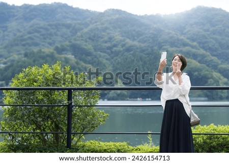 Middle-aged women taking selfies on holiday trips, sightseeing, etc.