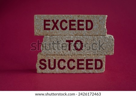 Exceed to succeed symbol. Concept red words Exceed to succeed on beautiful brick blocks. Beautiful red background. Business and exceed to succeed concept. Copy space.