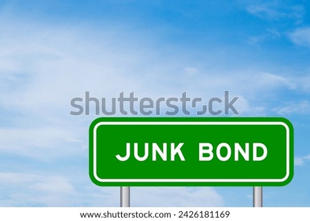 Green color transportation sign with word junk bond on blue sky with white cloud background