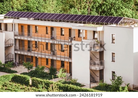 Solar Panels Roof. Solar Panel Station Energy System on Roof Building. Modern High-rise Multifamily Apartment Building with Solar Batteries in Green City of Germany. Royalty-Free Stock Photo #2426181919