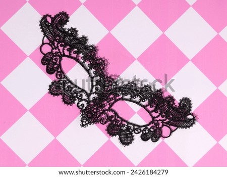 Mask on a checkered background, carnival days, annual celebration, party time, retro style.
