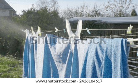 Evaporation of water of clothes drying in the backyard. Royalty-Free Stock Photo #2426184617