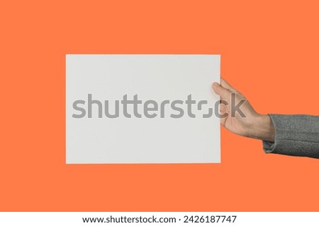 Female Hands Holding Blank Sheet of Paper.
