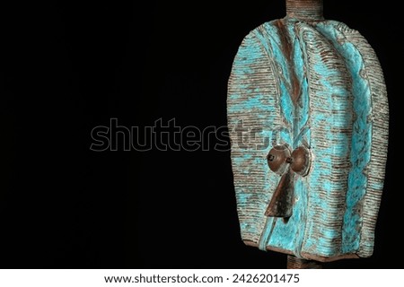 Close up of a wooden Kota reliquary figure from Gabon, isolated on a black background. Tribal African art, showcasing masterful craftsmanship and spiritual symbolism. Royalty-Free Stock Photo #2426201475
