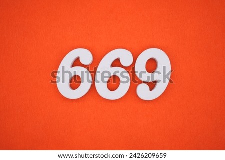 Orange felt is the background. The numbers 669 are made from white painted wood.