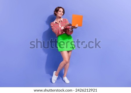 Full size photo of busy clever woman dressed print shirt look at laptop searching clothes in eshop isolated on blue color background