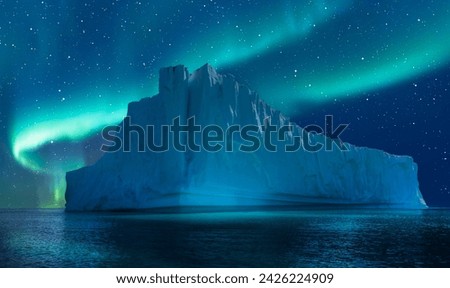 Iceberg floating in greenland fjord  
with aurora borealis - Greenland Royalty-Free Stock Photo #2426224909