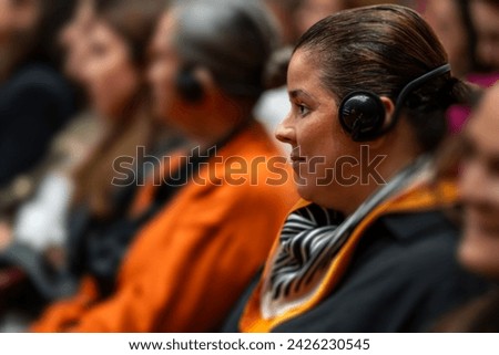 a set of headphones for simultaneous translation during negotiations in foreign languages. woman headphones used for simultaneous translation equipment simultaneous interpretation	