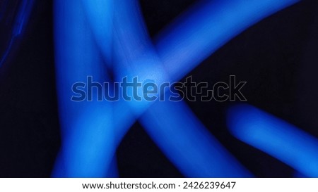 Vibrant blue light painting, illuminating the dark. Royalty-Free Stock Photo #2426239647