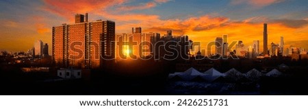 New York City High Rise Residential Red Brick Buildings in Brooklyn with Manhattan Skyline in the distant backgrounds at dramatic cloudy sunrise after winter snow storm, USA