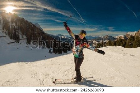 Young woman enjoying a view of a ski resort around Sela mountain, Selaronda, Dolomites, Italy Royalty-Free Stock Photo #2426263093
