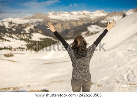 Young woman enjoying a view of a ski resort around Sela mountain, Selaronda, Dolomites, Italy Royalty-Free Stock Photo #2426263585