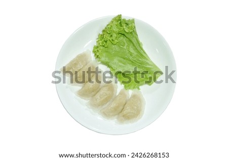 khanom Pang Sib Thai snack made from steamed flour stuffing mashed fish eating with fresh lettuce on plate Royalty-Free Stock Photo #2426268153