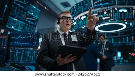 Stock Exchange Professional Communicating in an Open Outcry Method on a Trading Floor. Stylish Man Shouting and Using Hand Signals to Transfer Information About Buy and Sell Orders to Broker Royalty-Free Stock Photo #2426274611