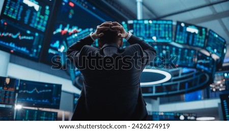 Stressed Stock Exchange Trader Can't Apprehend a Sudden Stock Market Collapse. Financial Crisis Concept with Stock Broker Saddened by Negative Ticker Information, Red Graphs and Real-Time Data Royalty-Free Stock Photo #2426274919