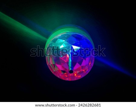 A shiny device that is placed on the ceiling and beautifully colors the space inside the room in a shiny way with the shimmer of light with different colors