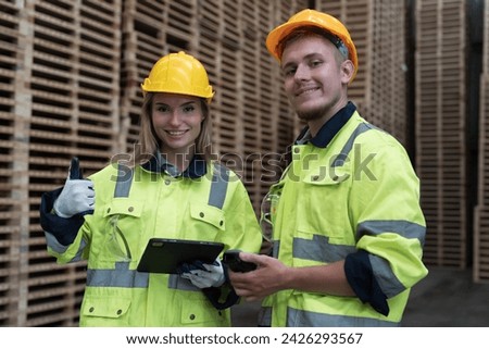Male and female warehouse worker working in lumber storage warehouse. Workers working in timber storage warehouse. Manufacturing and warehouse concept Royalty-Free Stock Photo #2426293567