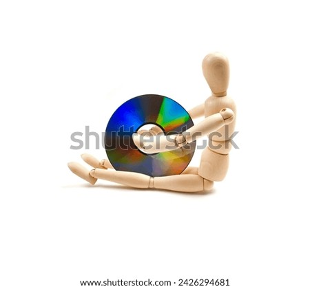 wood mannequin with CD-rom on white background Royalty-Free Stock Photo #2426294681