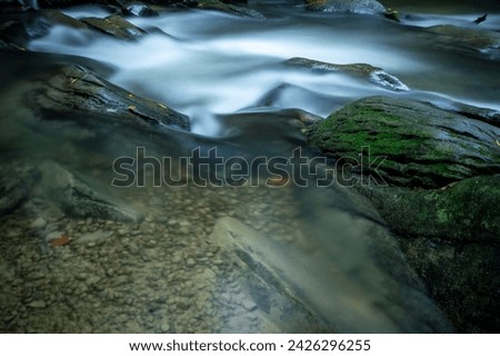 Close up of water in stream Hylaty torrent, fresh water flowing around boulders, long exposure photography, Bieszczady