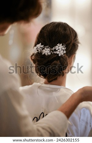 Hairdresser finishing a stylish hairstyle for a client in the beauty salon. stock photo