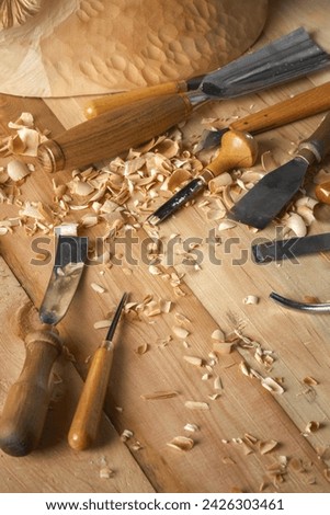 Timber, wood processing. Joinery work. Wood carving with work tools close up. Hand of carver carving wood. Craftsman carving with a gouge Royalty-Free Stock Photo #2426303461