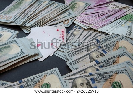banknotes of dollars, four ace of playing cards.