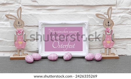 Easter decoration with Easter greetings written on a frame. German inscription says We wish our customers a happy Easter
