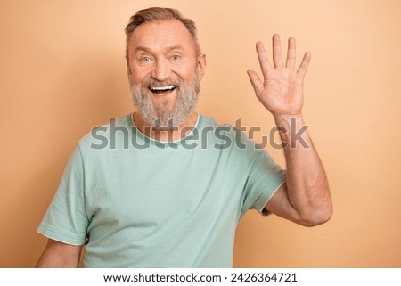 Photo of satisfied glad aged person beaming smile arm palm waving greeting isolated on beige color background Royalty-Free Stock Photo #2426364721