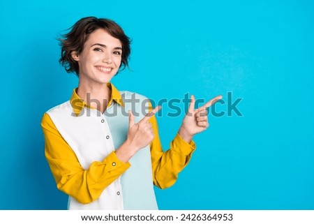 Portrait of young successful businesswoman in casual shirt direct fingers banner start your career isolated on blue color background
