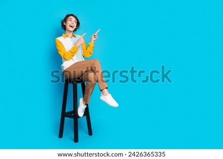 Photo of positive surprised girl manager sit chair stool look indicate offer isolated blue color background