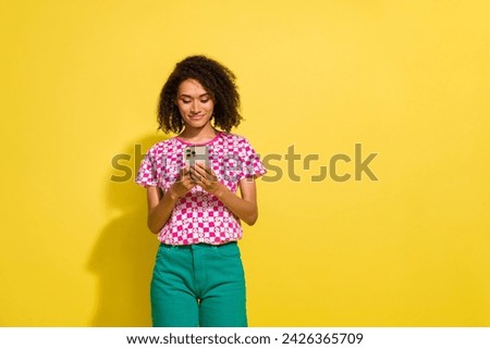 Photo of nice positive lady use apple iphone gadget empty space ad isolated on yellow color background