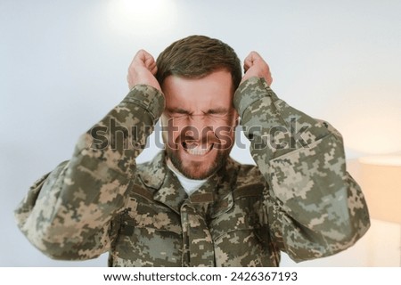 Depressed man recalling war days. Portrait of veteran soldier who has PTSD.