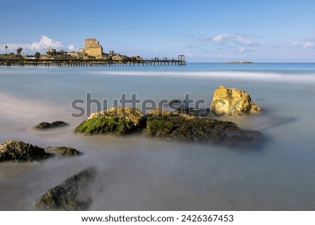 The cape with the ruins of the city and the fortress Chateau Pelerin on the Mediterranean Sea near the city of Atlit (Israel) is the last refuge of the Crusaders in the Holy Land. Long-exposure Royalty-Free Stock Photo #2426367453