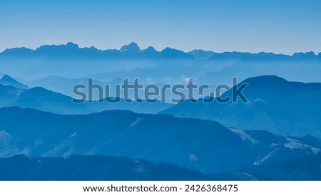 Panoramic view of magical mountain peaks of Karawanks and Julian Alps seen from Goldeck, Latschur group, Gailtal Alps, Carinthia, Austria, EU. Mystical atmosphere in Austrian Alps on sunny summer day. Royalty-Free Stock Photo #2426368475