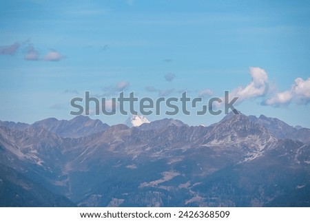 Panoramic view of Grossglockner seen from mountain Goldeck, Latschur group, Gailtal Alps, Carinthia, Austria. Scenic hiking trail along idyllic alpine meadow in Austrian Alps. Wanderlust in summer Royalty-Free Stock Photo #2426368509