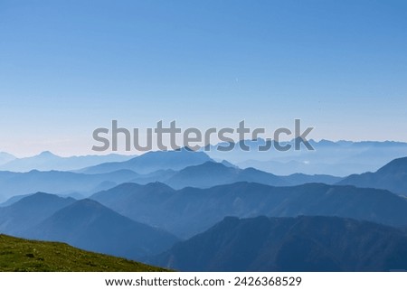 Panoramic view of magical mountain peaks of Karawanks and Julian Alps seen from Goldeck, Latschur group, Gailtal Alps, Carinthia, Austria, EU. Mystical atmosphere in Austrian Alps on sunny summer day. Royalty-Free Stock Photo #2426368529