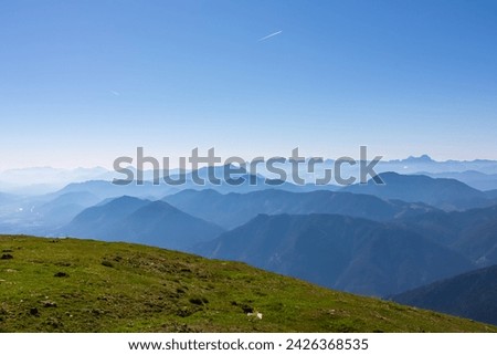 Panoramic view of magical mountain peaks of Karawanks and Julian Alps seen from Goldeck, Latschur group, Gailtal Alps, Carinthia, Austria, EU. Mystical atmosphere in Austrian Alps on sunny summer day. Royalty-Free Stock Photo #2426368535
