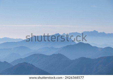 Panoramic view of magical mountain peaks of Karawanks and Julian Alps seen from Goldeck, Latschur group, Gailtal Alps, Carinthia, Austria, EU. Mystical atmosphere in Austrian Alps on sunny summer day. Royalty-Free Stock Photo #2426368577