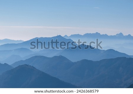Panoramic view of magical mountain peaks of Karawanks and Julian Alps seen from Goldeck, Latschur group, Gailtal Alps, Carinthia, Austria, EU. Mystical atmosphere in Austrian Alps on sunny summer day. Royalty-Free Stock Photo #2426368579