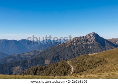 Panoramic view of rugged mountain peak Staff seen from Goldeck, Latschur group, Gailtal Alps, Carintha, Austria. High alpine road in Austrian Alps. Unique ridge surrounded by alpine forest Royalty-Free Stock Photo #2426368603