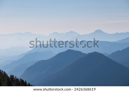 Panoramic view of magical mountain peaks of Karawanks and Julian Alps seen from Goldeck, Latschur group, Gailtal Alps, Carinthia, Austria, EU. Mystical atmosphere in Austrian Alps on sunny summer day. Royalty-Free Stock Photo #2426368619