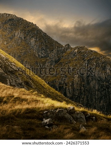 Rocky mountain peaks bathed in sunset light in the Scottish Highlands