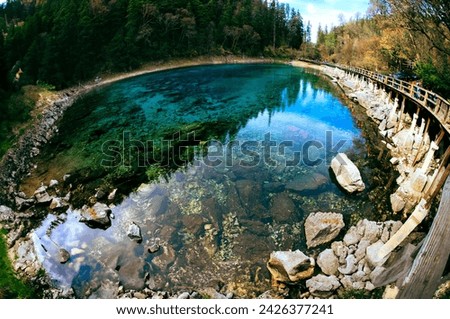 Jiuzhaigou Valley National Park, Sichuan China, Colorful mirror Lake in Jiuzhaigou , trees and mountain. Jiuzhaigou nature reserve (Jiuzhai Valley National Park),